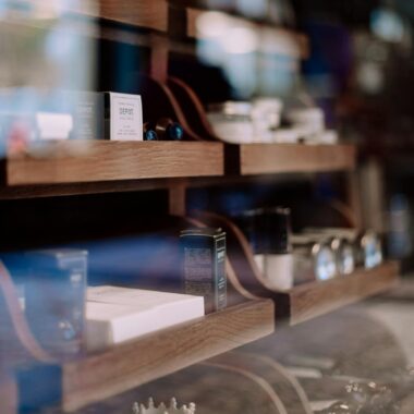 Close-up of a stylish barber shop shelf with grooming products in Geneva, Switzerland.