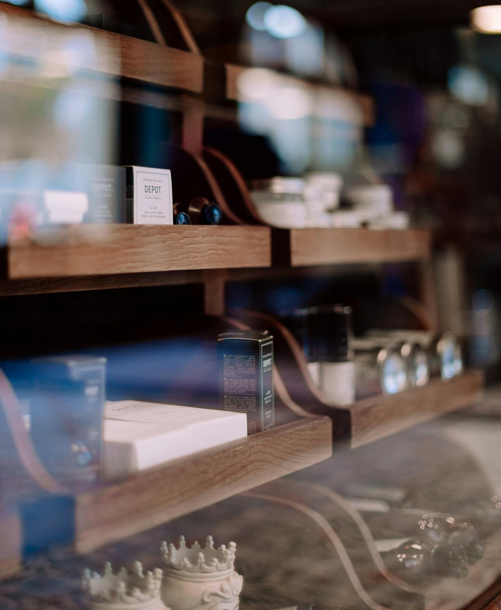 Close-up of a stylish barber shop shelf with grooming products in Geneva, Switzerland.